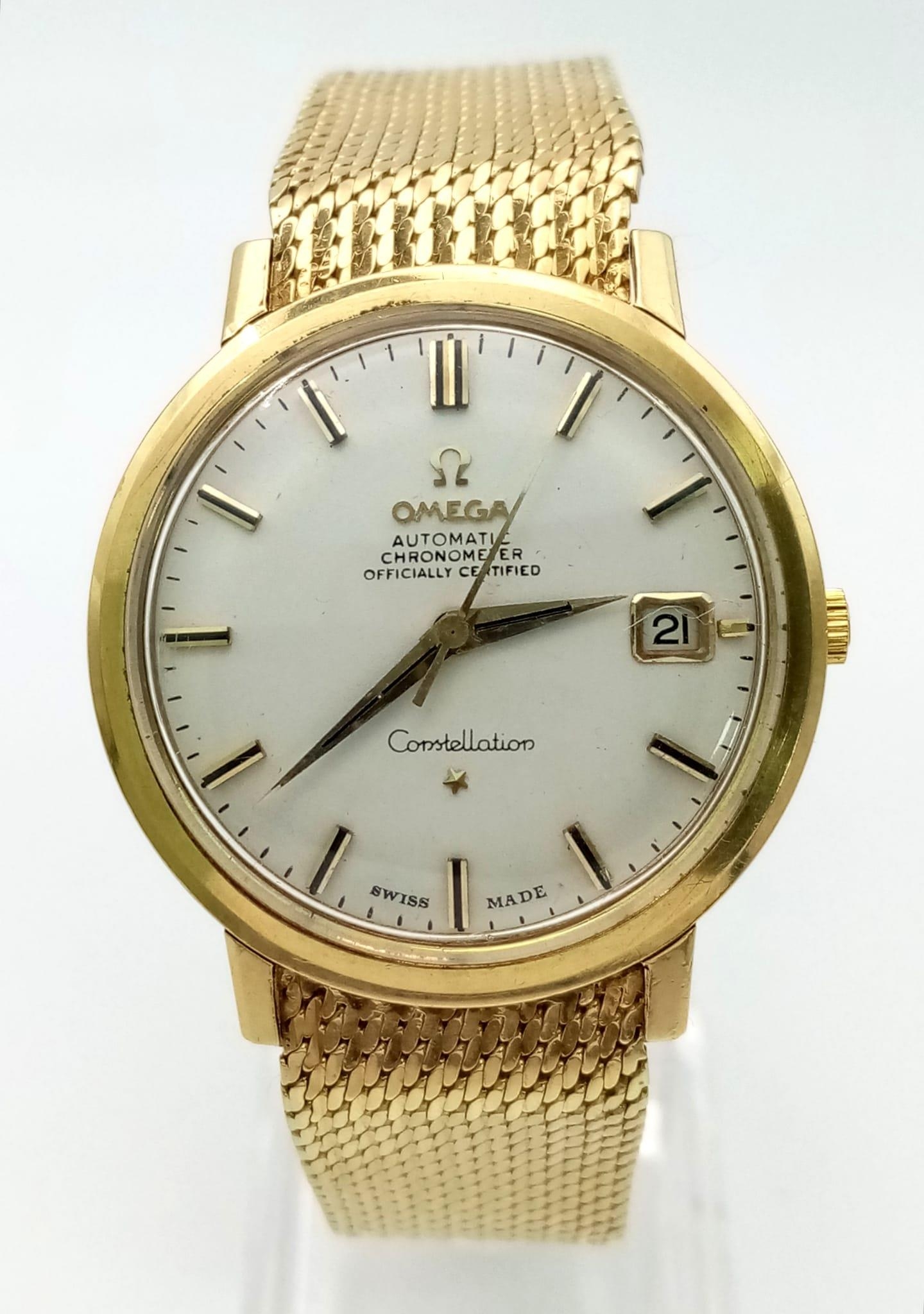 A 1960s 18K Solid Gold Omega Constellation Gents Watch. 18K gold strap and case - 36mm. White dial