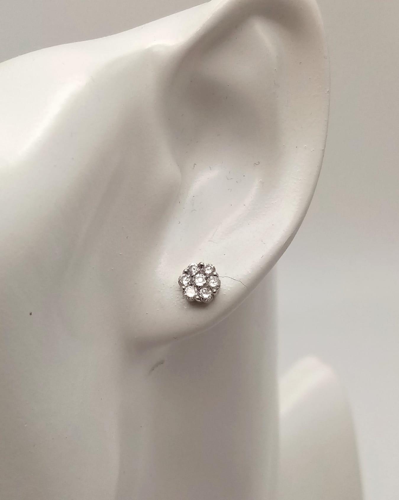 A Pair of 18K White Gold and Diamond Stud Earrings. 14 diamonds in total - 0.40ct. 1.20g total