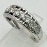 An 18K White Gold and Graduated Diamond Half-Eternity Ring. 11 diamonds - 0.8ct approx. Size M/N.