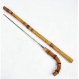 An Antique Bamboo Walking Stick/Cane with Hidden Sword. Markings on band. 93cm total length. 8cm