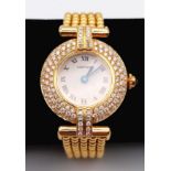 A Cartier 18K Yellow Gold and Diamond Ladies Watch. Gold ball-link bracelet. Gold circular case -