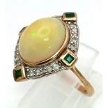 A Vintage 9K Yellow Gold Opal, Emerald and Diamond Ring. Large central fire opal surrounded with