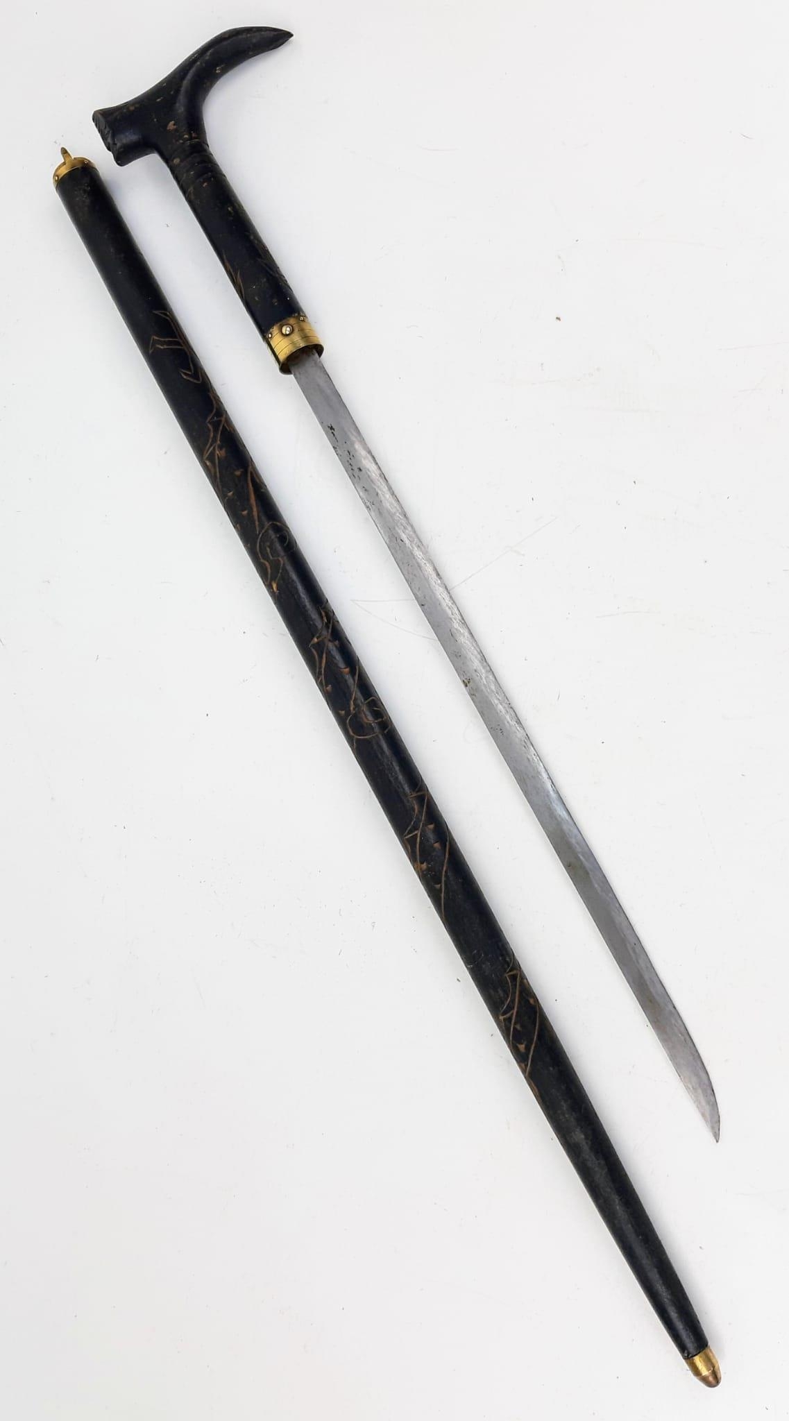 An Antique Walking Stick with Hidden Short Sword. Push button release on a gilded band.