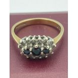 9 carat GOLD and SAPPHIRE TRILOGY RING. Having three SAPPHIRES set to top with DIAMOND surround.