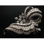 A 1950s Diamond Floral Spray Brooch - set with round and baguette-cut diamonds. Mounted in platinum.