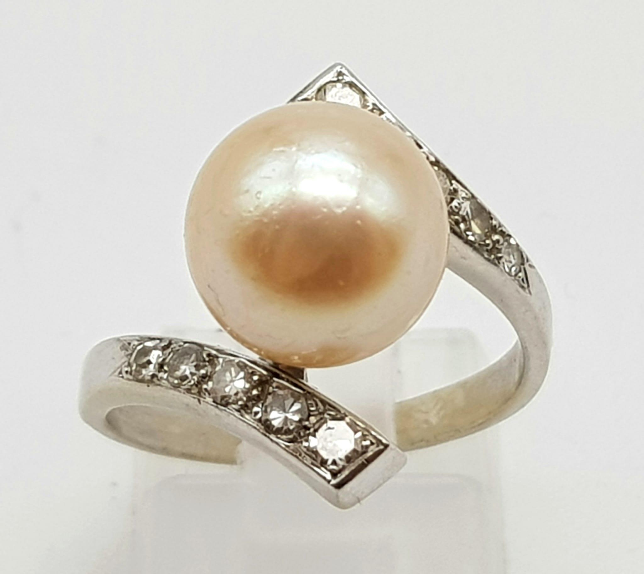 An 18K White Gold Diamond and Natural Pearl Ring. Size N. 5.2g.