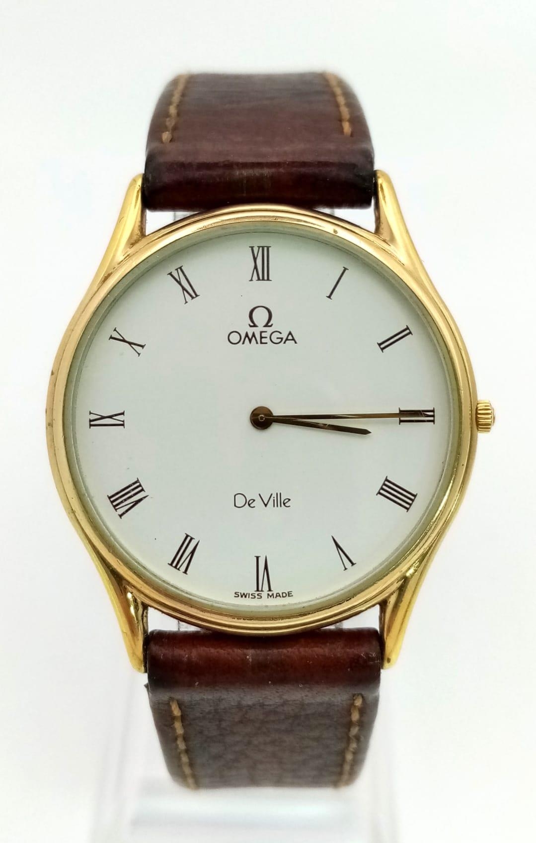 An Omega Deville Quartz Gents Mid-Size watch. Brown leather strap. Two tone case - 30mm. White dial.