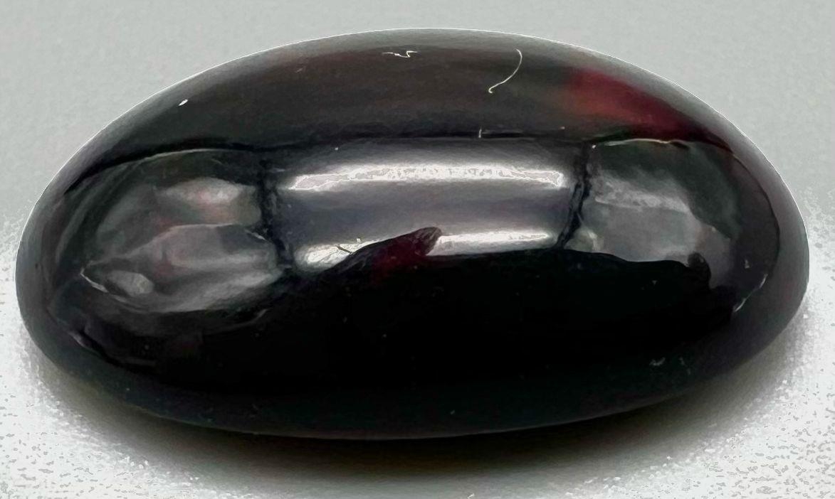 A 5.89ct Black Fire Ethiopian Opal - Oval Cabochon. Certified with ITLGR.