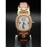 A Patek Phillipe Gold and Diamond Ellipse Ladies Watch. Pink leather strap and gold buckle. Oval