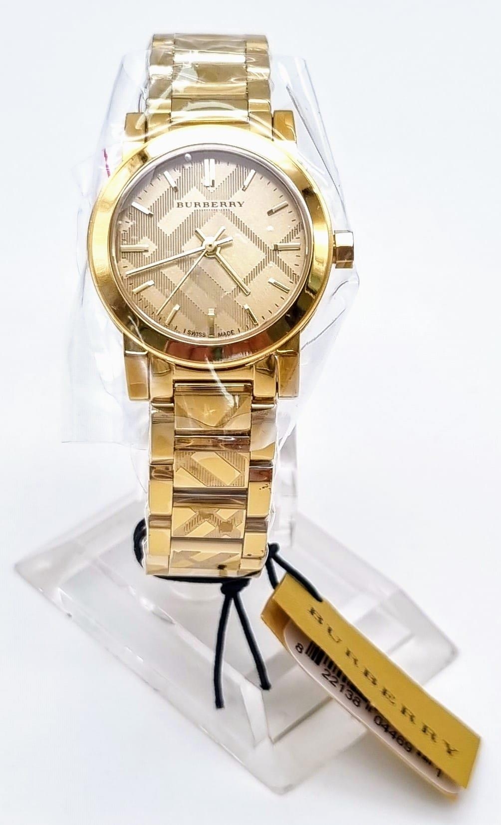 A rare and beautiful, BURBERRY, THE CITY, ladies watch with engraved check bracelet. 27mm case,