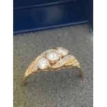 9 carat GOLD AND ZIRCONIA TRILOGY RING with attractive twist detail to shoulders. Full UK