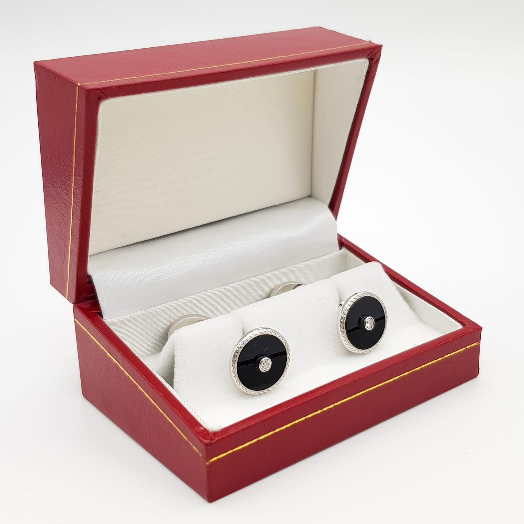 A Pair of Edwardian 18K White Gold Diamond and Onyx Cufflinks. Makers mark of Deakin and Francis.