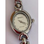 Ladies Quartz designer wristwatch in silver tone , having Oval face and finished in smooth stainless