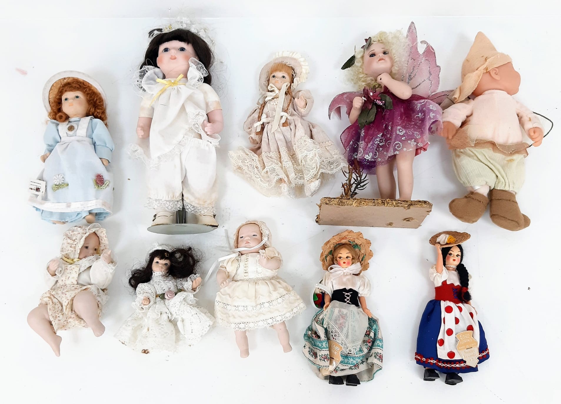 A collection of 10 varied porcelain dolls.