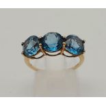 9k Yellow Gold Ring With Trilogy blue Topaz Circular Stones.2.7grams .Size N/O.