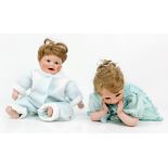 A pair of porcelain dolls with markings to the back of their head and neck. In excellent