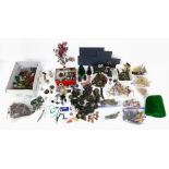 A potpourri of dollhouse garden accessories including flowers, potted plants, bushes and trees.