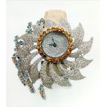 AN 18K WHITE GOLD AND DIAMOND DRESS WATCH BY COBRA , DIAMOND RAYS AND BEZEL. ONE SMALL CITRINE