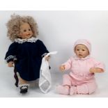 A pair of porcelain dolls. One by the Hamilton Collection and one unmarked. In excellent