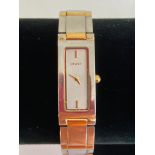 Ladies designer Quartz wristwatch in silver tone with gold tone detail. Having rectangular silver