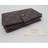 A Louis Vuitton Monogram Canvas Purse/Wallet. Zipped interior compartment. Wallet pocket section. In