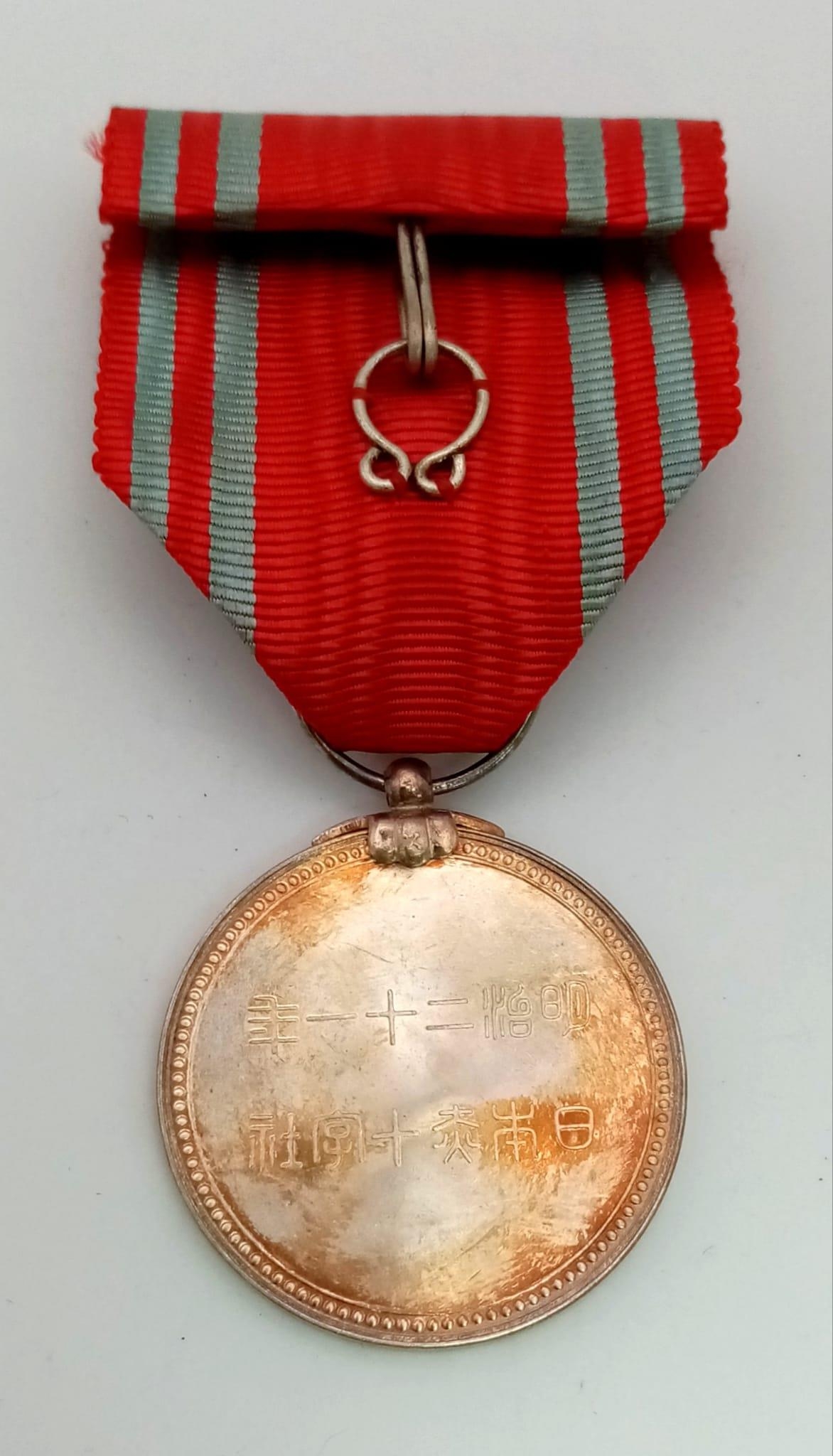 Japanese WW2 Red Cross Order Medal with Rosette, comes in Original Presentation Box.