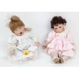 A Pair of porcelain dolls with interesting markings to the backs of their heads. In excellent
