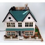 An awe-inspiring Victorian style dollhouse that is tastefully decorated and fitted out. Full of