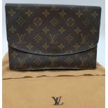 A Louis Vuitton Clutch Flap Bag. Monogram canvas with a zip front pocket. Brown leather interior. 23