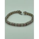 Hallmarked SILVER TENNIS BRACELET, set with double lines of Sparkling Pink and White zirconias. 19