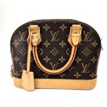 A Louis Vuitton Alma Handbag. Monogram canvas and brown leather. In very good condition but please