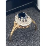 9 carat GOLD,SAPPHIRE and DIAMOND RING.Having oval Sapphire set to top with Diamond surround. Full