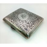 An Antique Silver Cigarette Case. Engraved scroll decoration with initialled cartouche. Gilded