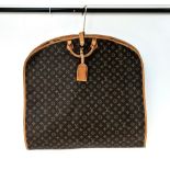 A Louis Vuitton Garment Bag. Monogram brown canvas and leather. Zipped opening with hanging