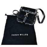 A Karen Millen Faux Fur and Black Leather Handbag. Silver tone hardware. Three graduating inner