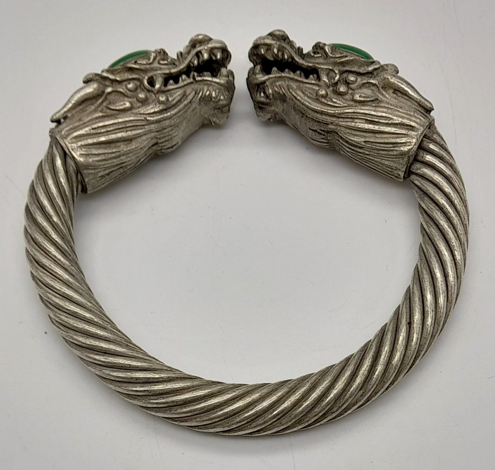 A Tibetan Silver Twin Dragon Twisted Bangle/Bracelet with Green Jade head decoration. 7cm inner - Image 3 of 3
