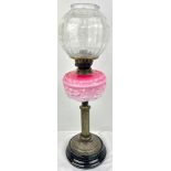 A Wonderful Antique Oil Lamp with a Christopher Wray Glass Shade. 64cm tall. One small blemish on