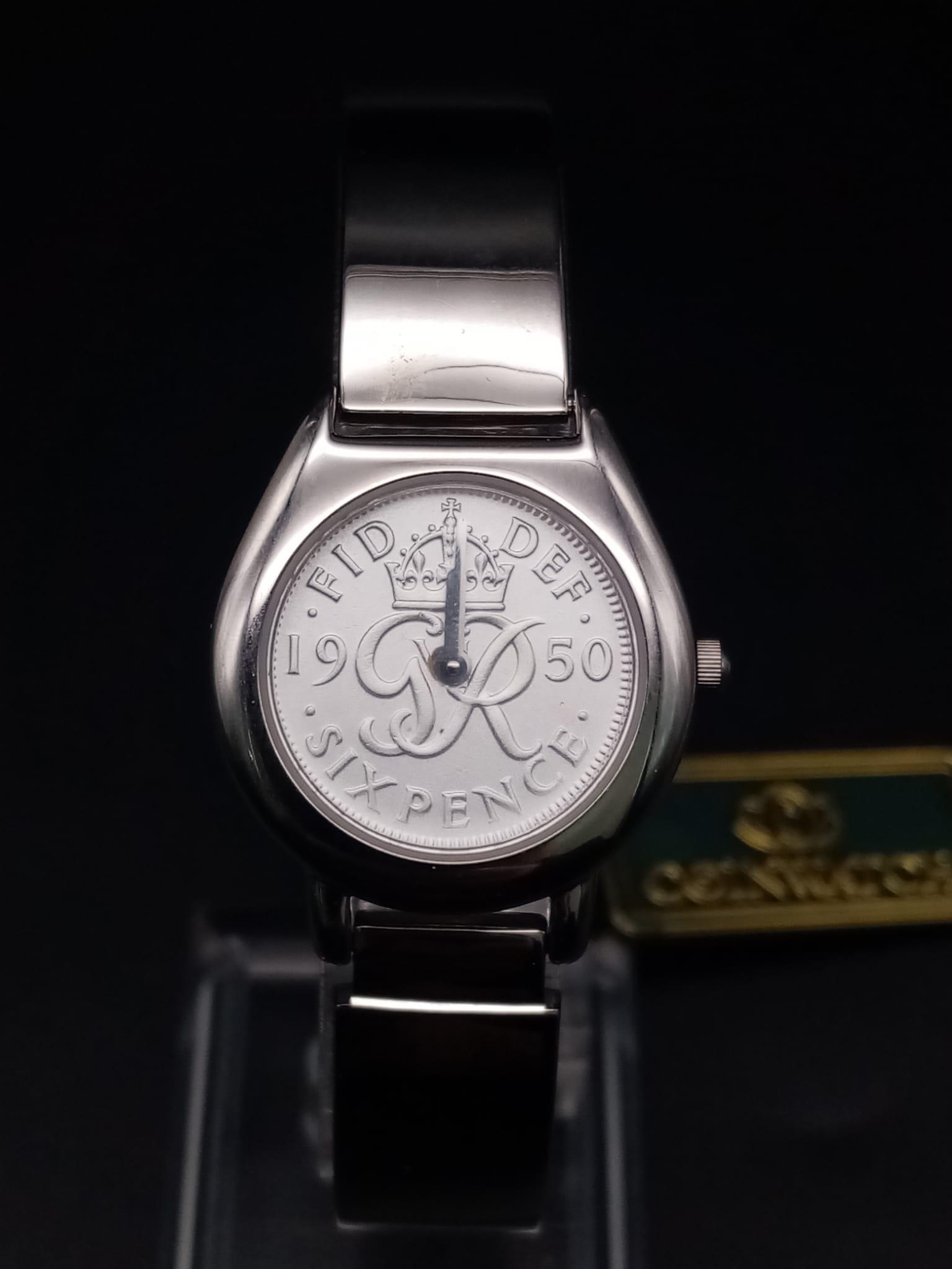A ladies COIN WATCH in original presentation box. 25 mm case, stainless steel construction, in new/
