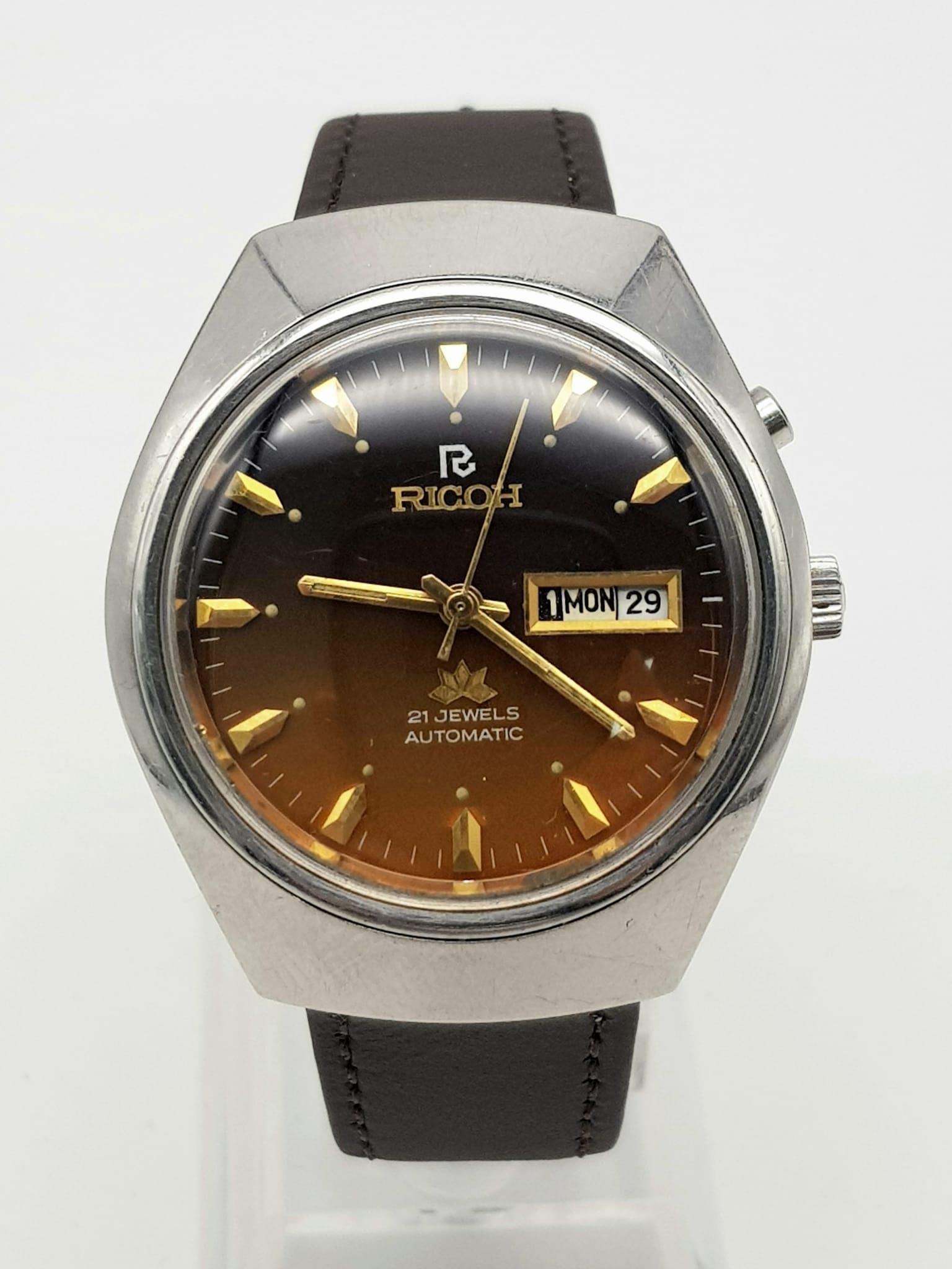 A Vintage Ricoh 21 Jewel Automatic Gents Watch. Brown leather strap with golden brown dial.