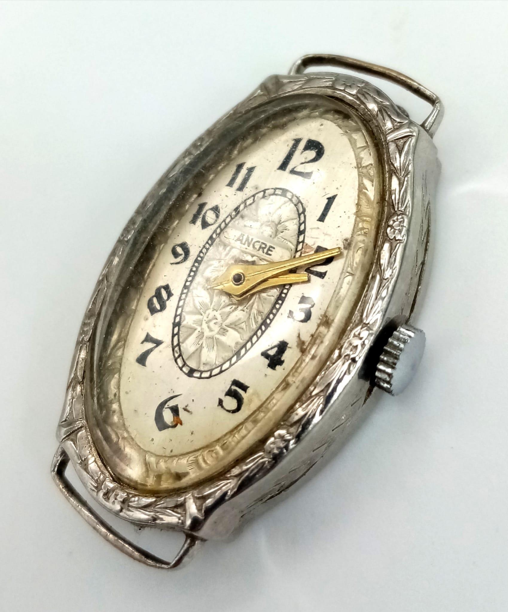 A vintage, 14K white gold ladies watch. Oval case 27 x 16 mm, with gold tone hands.