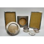 A Mixed 925 Silver Lot to Include Three Silver Napkins Rings, and Four Wood and Silver Photo Frames.