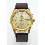 A Vintage Orient 21 Jewel Crystal Gents Watch. Brown leather strap. Two tone case - 36mm. Gold