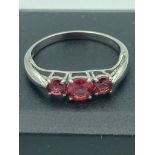9k WHITE GOLD RUBY RING. Having three sparkling faceted rubies mounted to top. Full UK hallmark. 1.7