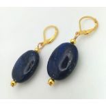 A Pair of Oval Lapis Lazuli Drop Earrings. Gilded touches and ear clasp. 33mm drop.
