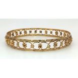 A vintage (60s), 14K yellow gold, handmade bangle. In very good condition and presented in a red
