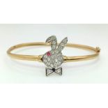 A 9K yellow gold, stone set, Playboy bunny bangle with safety catch. Weight: 4.5 g.