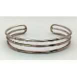 A unisex, three row, sterling silver cuff bangle. Weight: 23.9 g.