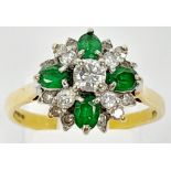 An 18K Yellow Gold Emerald and Diamond Decorative Floral Ring. Quality stones in an attractive