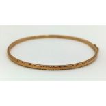 A Vintage 9K Yellow Gold Bangle. Slot and clip clasp. 3.62g