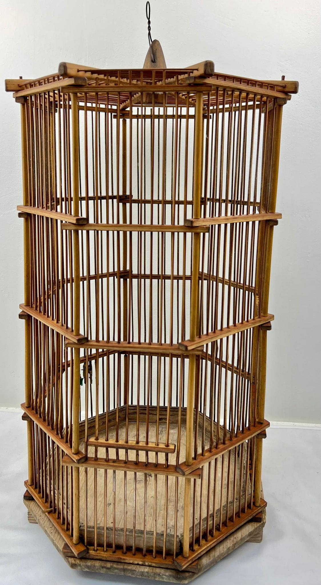 A VERY RARE ANTIQUE CHINESE BAMBOO BIRD CAGE FROM THE LATE 1800'S . HIGH HEXAGONAL DESIGN AND IN